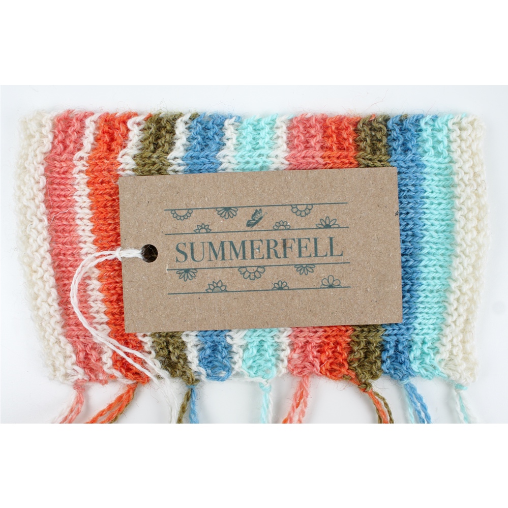 Knitted swatch of the Summerfell colours with a Summerfell yarn label on top