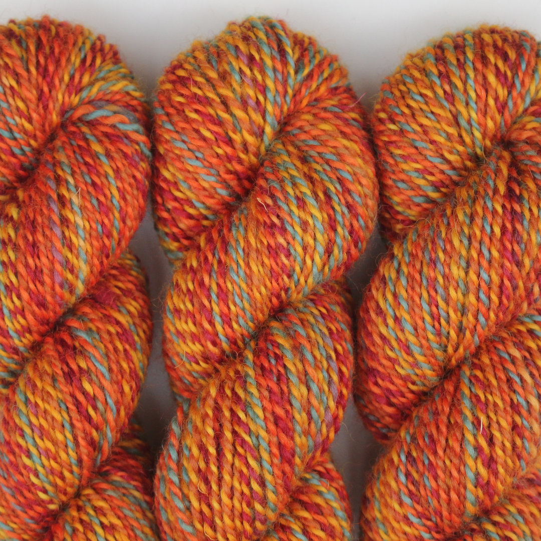 Warm orange marled skeins of Chimera