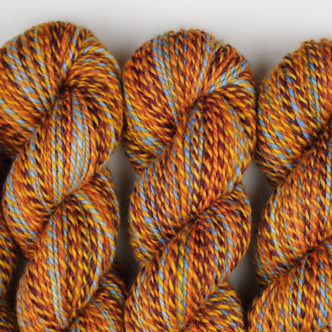 Warm yellow and brown marled skeins of Chimera